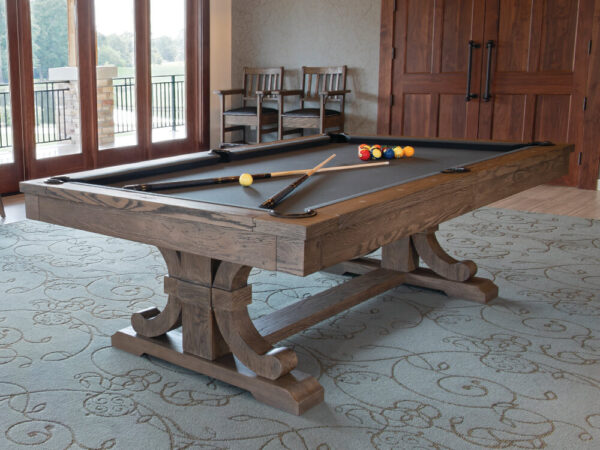pool table with pool cues on it in a carmel color